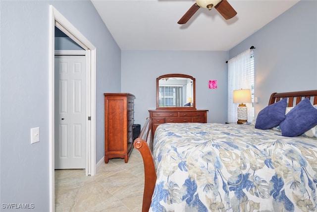 bedroom with ceiling fan and baseboards