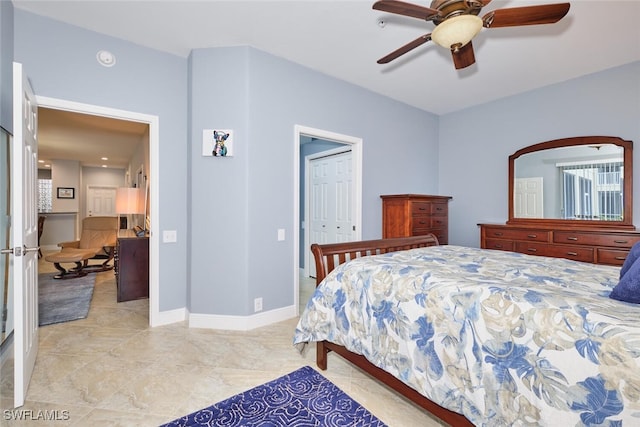 bedroom featuring a ceiling fan, a closet, and baseboards