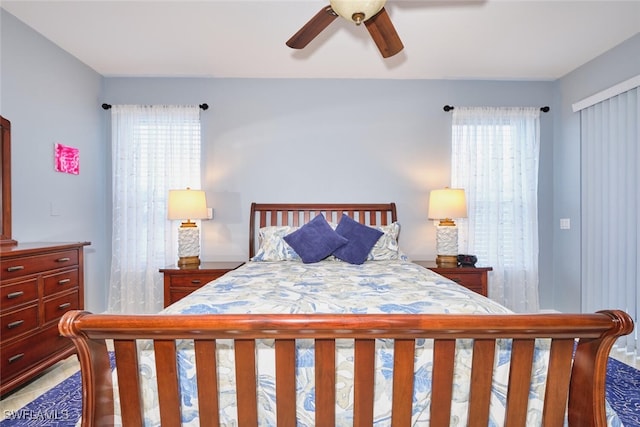 bedroom featuring a ceiling fan and multiple windows