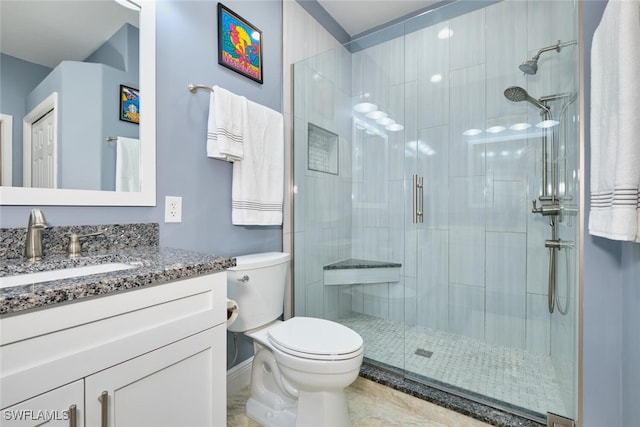 full bath featuring vanity, a shower stall, and toilet