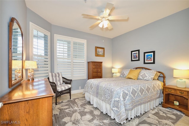 bedroom with a ceiling fan and baseboards