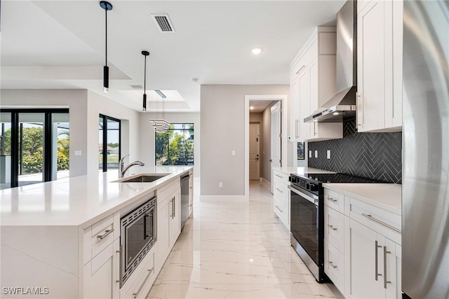 1316 SW 23rd St, Cape Coral, FL 33991 - kitchen featuring appliances with stainless steel finishes, a sink, baseboards, backsplash, and light marble finish flooring
