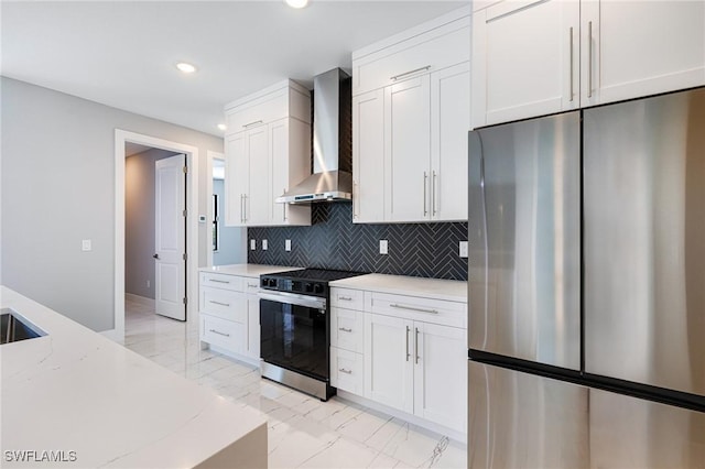 1316 SW 23rd St, Cape Coral, FL 33991 - kitchen with stainless steel refrigerator, range with electric cooktop, wall chimney exhaust hood, light marble finish flooring, and white cabinetry