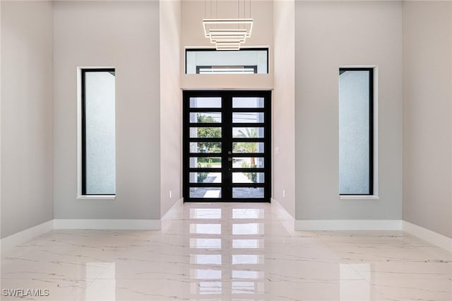 1316 SW 23rd St, Cape Coral, FL 33991 - foyer with marble tiled floors, baseboards, french doors, and a towering ceiling