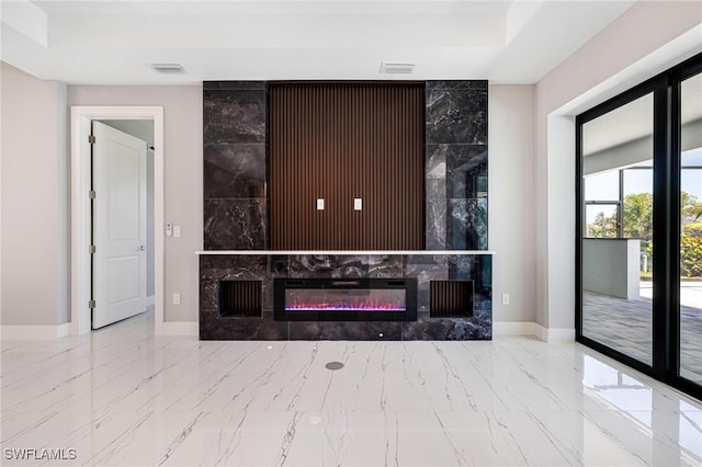1316 SW 23rd St, Cape Coral, FL 33991 - living room featuring marble tiled flooring, baseboards, a premium fireplace, and a raised ceiling