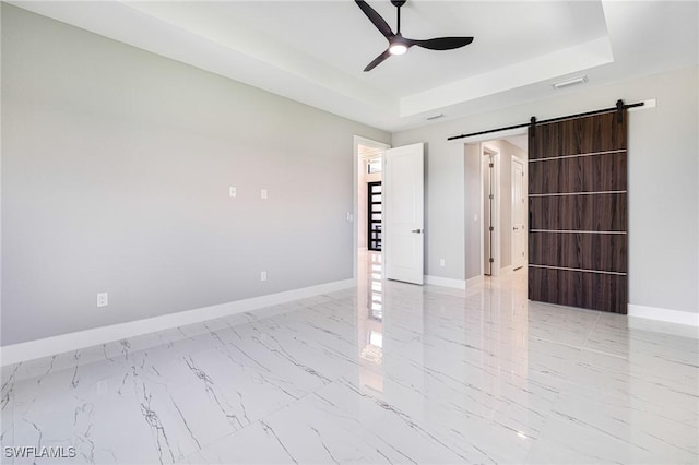1316 SW 23rd St, Cape Coral, FL 33991 - spare room featuring a ceiling fan, a tray ceiling, light marble finish floors, and baseboards