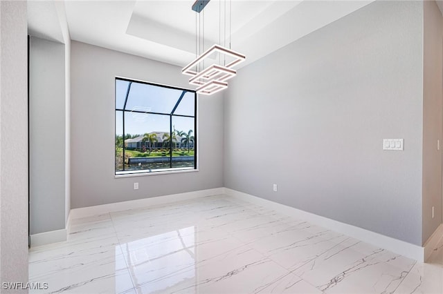 1316 SW 23rd St, Cape Coral, FL 33991 - spare room featuring light marble finish flooring, a chandelier, baseboards, and a tray ceiling