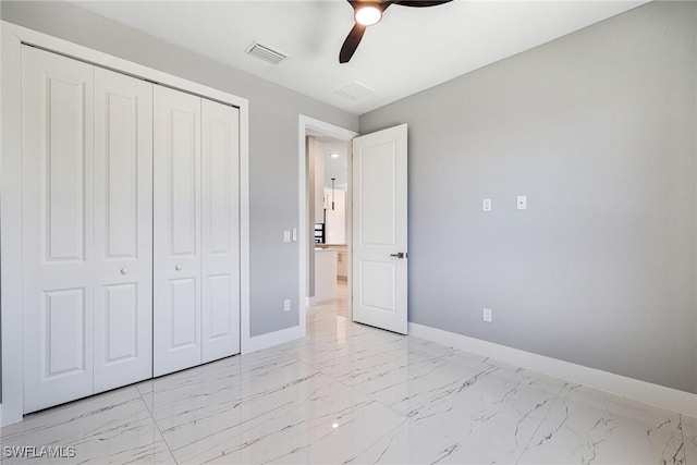 1316 SW 23rd St, Cape Coral, FL 33991 - unfurnished bedroom with baseboards, a closet, light marble finish floors, and a ceiling fan