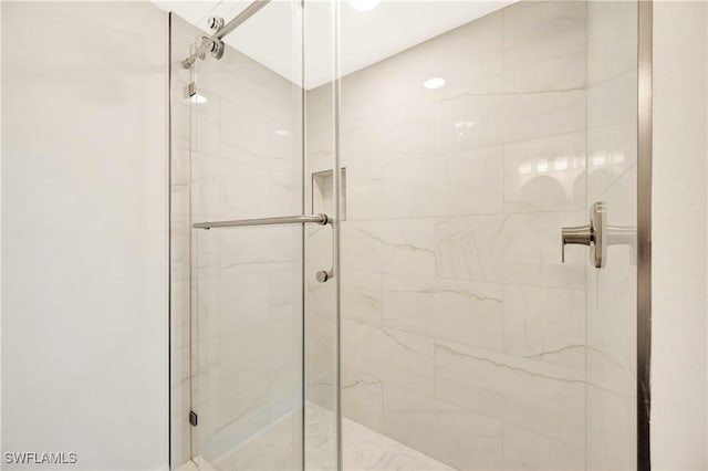 bathroom with a marble finish shower