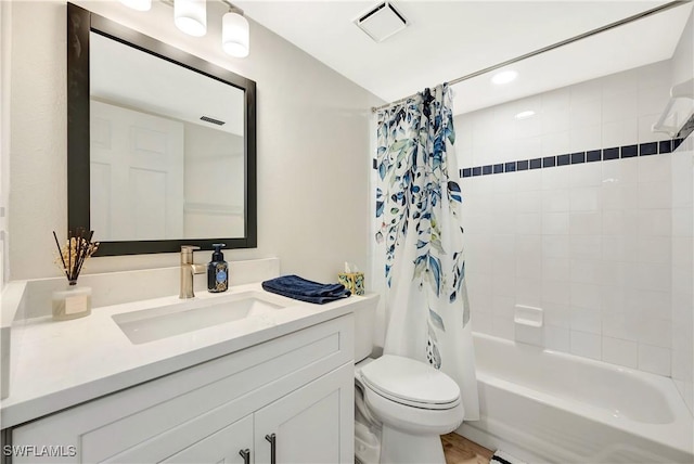 bathroom with visible vents, shower / tub combo, vanity, and toilet