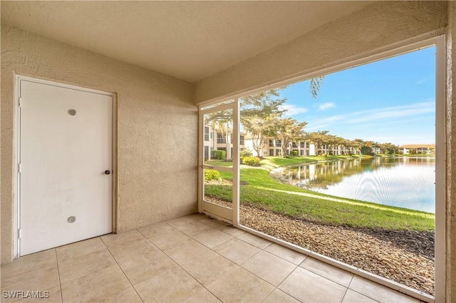 unfurnished sunroom featuring a water view and a wealth of natural light