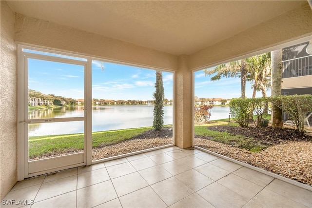 6448 Huntington Lakes Cir Unit 102, Naples, FL 34119 - unfurnished sunroom with a water view, tile patterned floors, and a textured wall