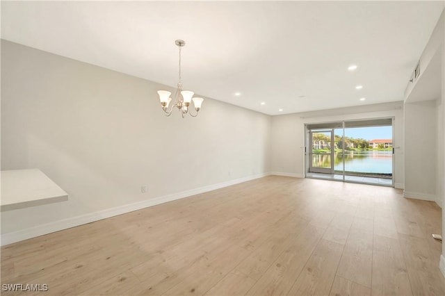 6448 Huntington Lakes Cir Unit 102, Naples, FL 34119 - spare room with a chandelier, light wood finished floors, and recessed lighting