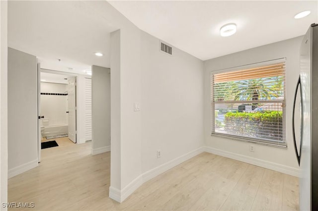 empty room with baseboards, recessed lighting, visible vents, and light wood-style floors