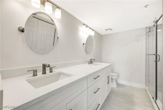 full bathroom featuring marble finish floor, a sink, a shower stall, and double vanity