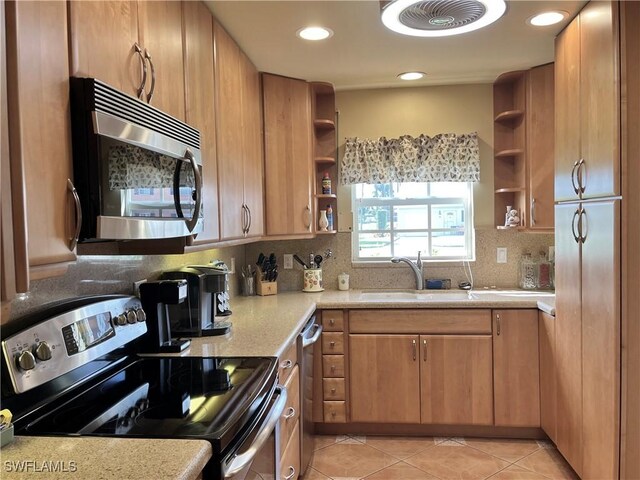 kitchen with a sink, visible vents, appliances with stainless steel finishes, open shelves, and tasteful backsplash