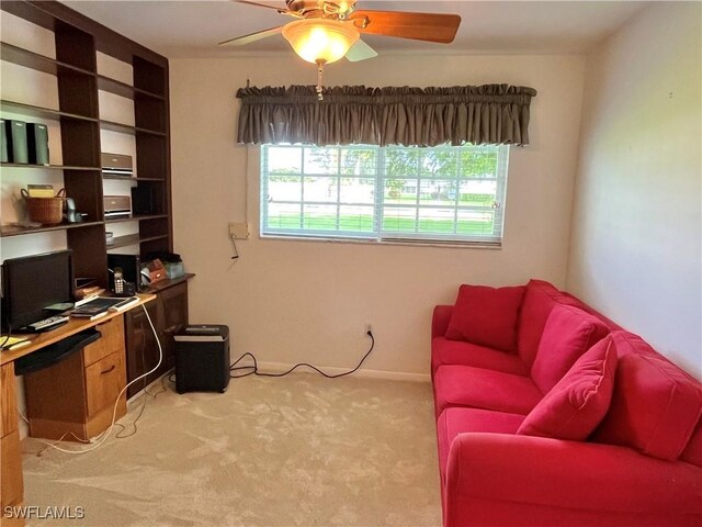 office space featuring a wealth of natural light, light carpet, and ceiling fan