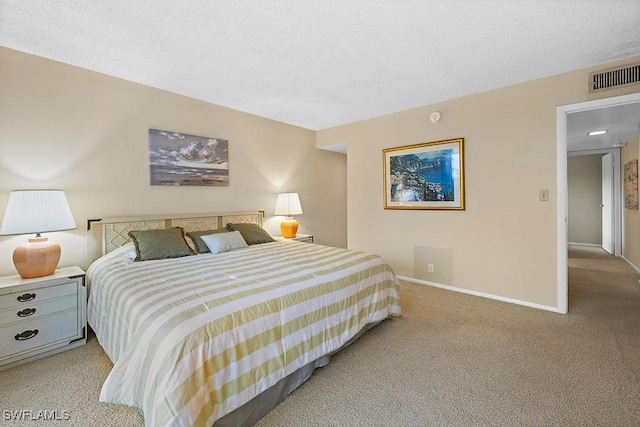 bedroom with light carpet, visible vents, a textured ceiling, and baseboards