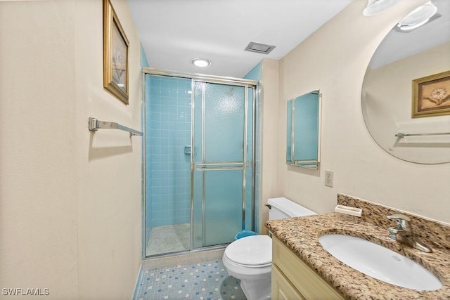 full bathroom featuring vanity, toilet, and a shower stall