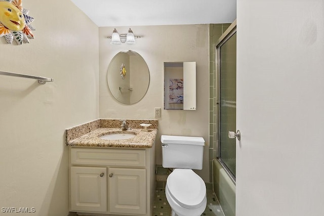 bathroom featuring enclosed tub / shower combo, toilet, and vanity