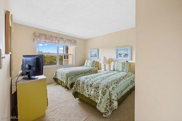 bedroom featuring a textured ceiling and carpet floors