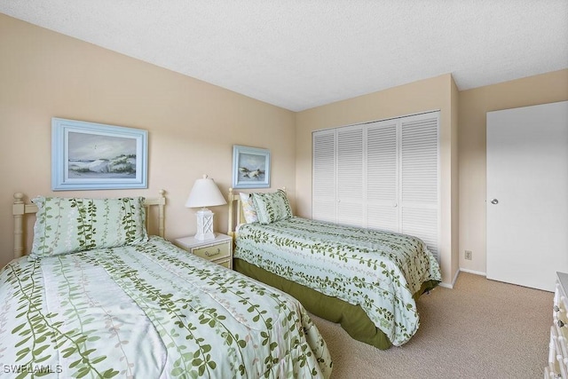 bedroom featuring baseboards, a closet, carpet floors, and a textured ceiling