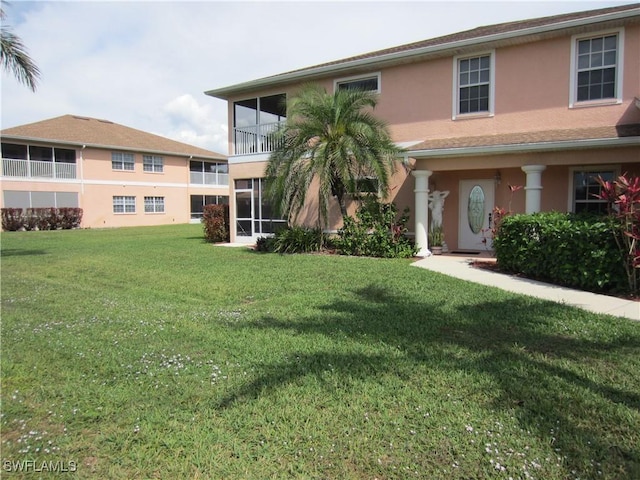 view of front facade featuring a front yard and stucco siding