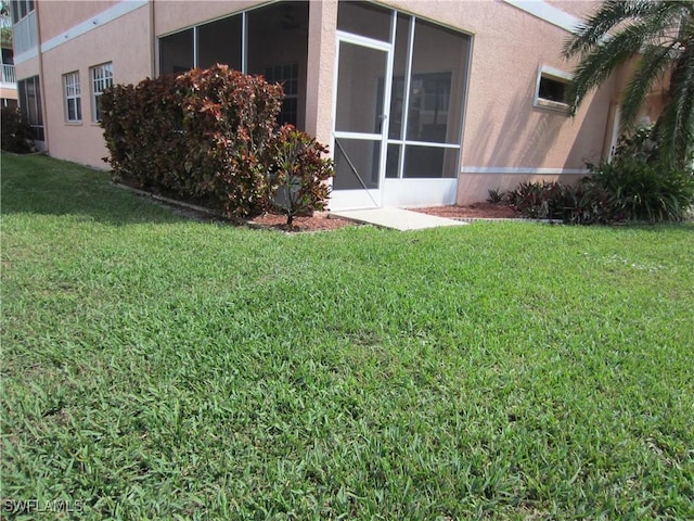 view of yard featuring a sunroom