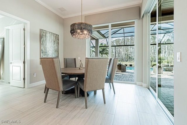 dining area featuring ornamental molding, a notable chandelier, and baseboards