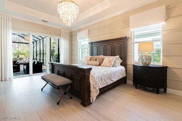 bedroom with a tray ceiling, a notable chandelier, visible vents, access to outside, and baseboards