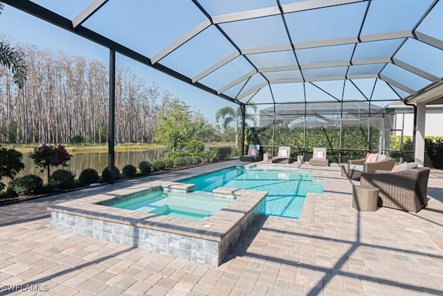 view of pool featuring a patio, a lanai, and a pool with connected hot tub