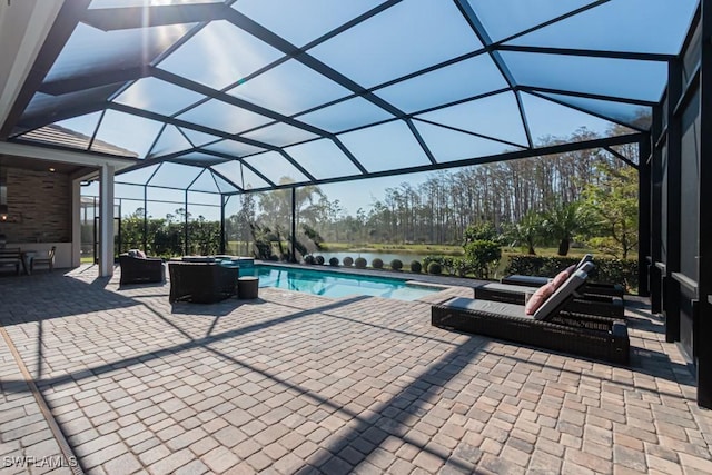 view of pool with glass enclosure, a patio area, a pool with connected hot tub, and outdoor lounge area