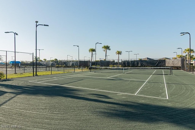 view of sport court featuring fence