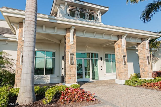 doorway to property with stucco siding and french doors