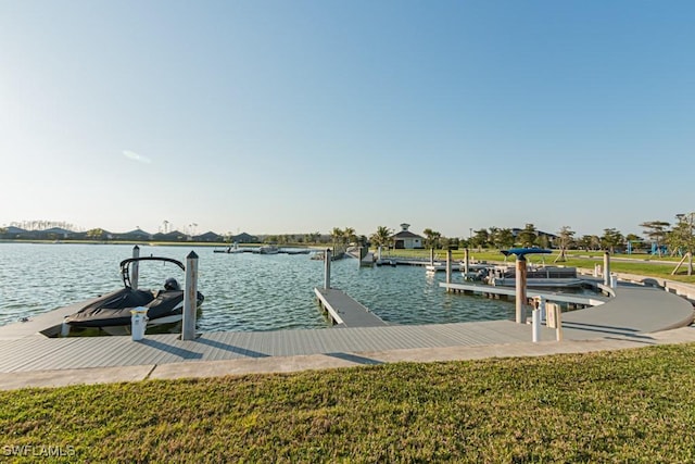 dock area featuring a water view and a lawn