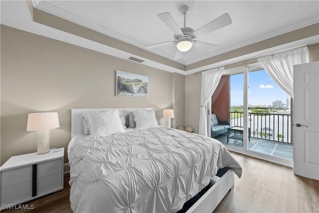 bedroom featuring visible vents, ceiling fan, ornamental molding, wood finished floors, and access to exterior