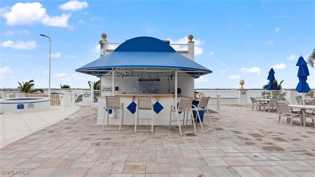 view of patio / terrace featuring outdoor wet bar, outdoor dining area, and exterior kitchen