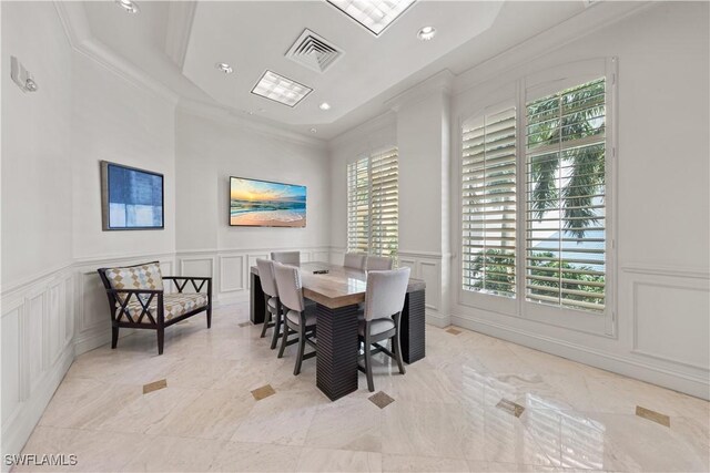 dining room featuring crown molding, recessed lighting, visible vents, and a decorative wall