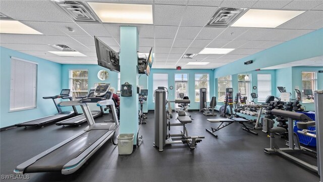 gym featuring a paneled ceiling and visible vents