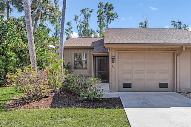 view of front of house featuring driveway, a shingled roof, and an attached garage