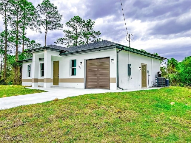 exterior space featuring driveway, an attached garage, and central AC unit