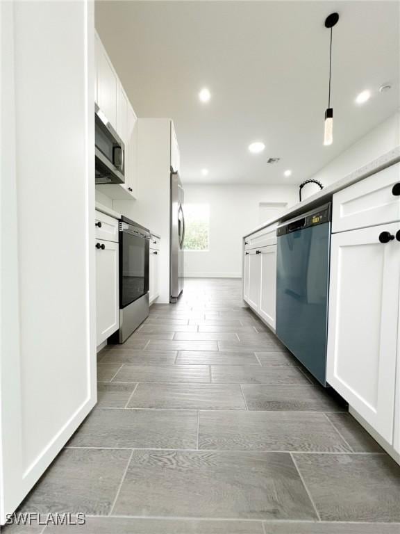 kitchen with white cabinetry, stainless steel appliances, decorative light fixtures, and recessed lighting