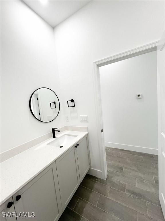 bathroom featuring baseboards and vanity