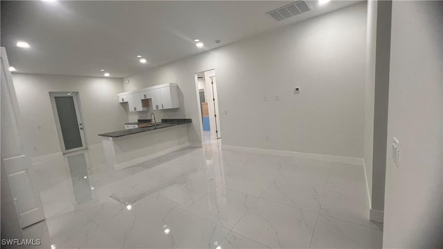 interior space with baseboards, marble finish floor, visible vents, and recessed lighting