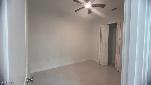 empty room with a ceiling fan, visible vents, and baseboards