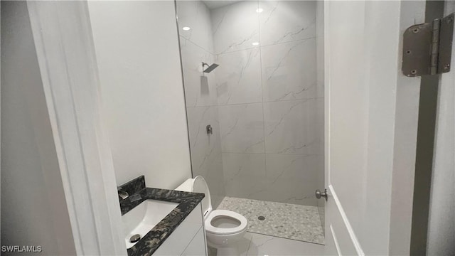 full bathroom featuring toilet, a stall shower, and vanity