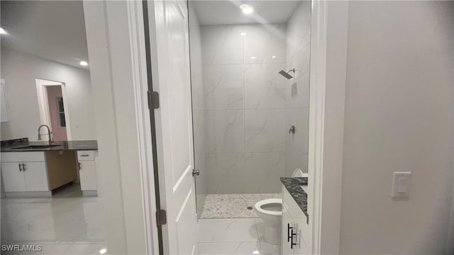 bathroom featuring a marble finish shower, marble finish floor, vanity, and toilet