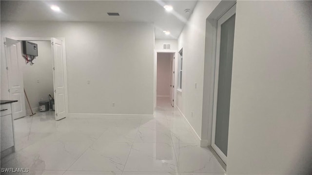 hall with marble finish floor, visible vents, and baseboards