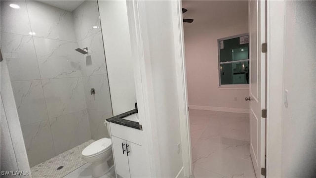 full bath featuring toilet, marble finish floor, and a marble finish shower