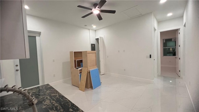 empty room with marble finish floor, recessed lighting, attic access, and baseboards